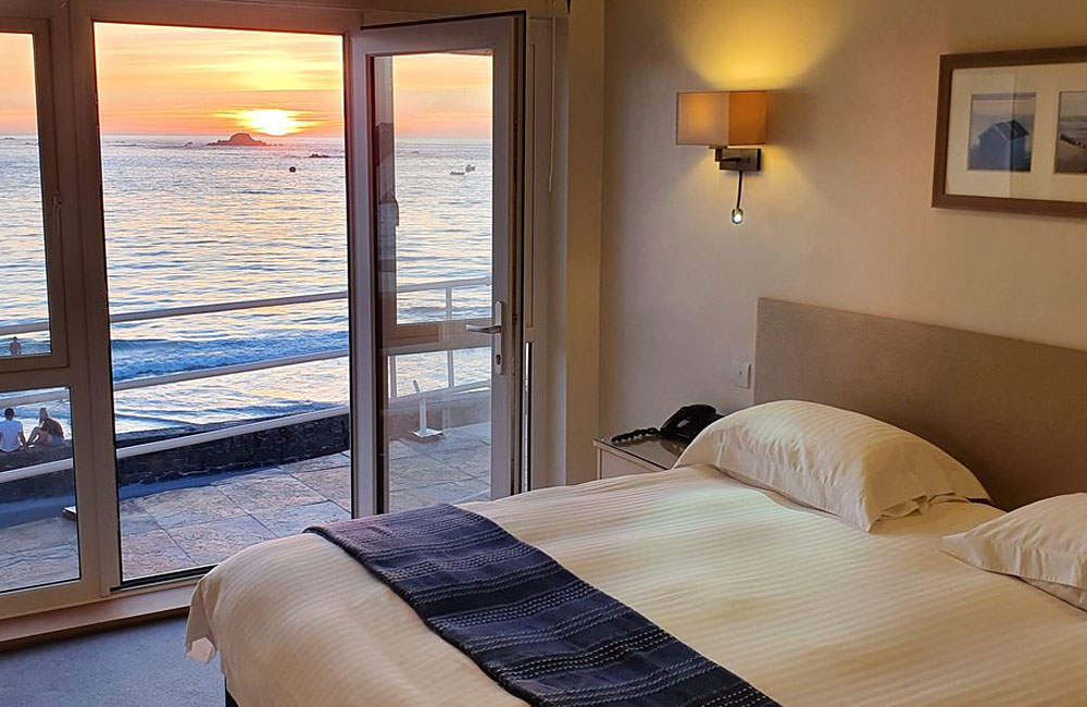 Cobo Bay bedrooms with seaviews and balconies.